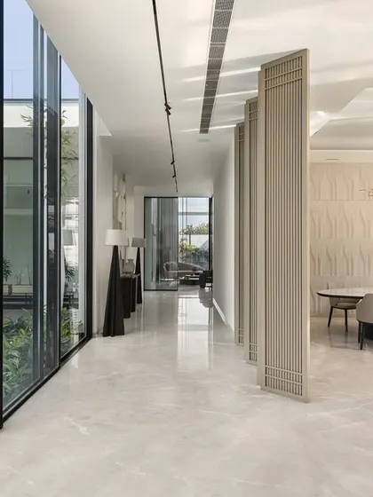 This corridor in our Amritsar project features a floor-to-ceiling glass wall that looks out onto a tranquil water garden. The design ensures that even transitional spaces are connected to nature, creating a quiet balance of form and function.