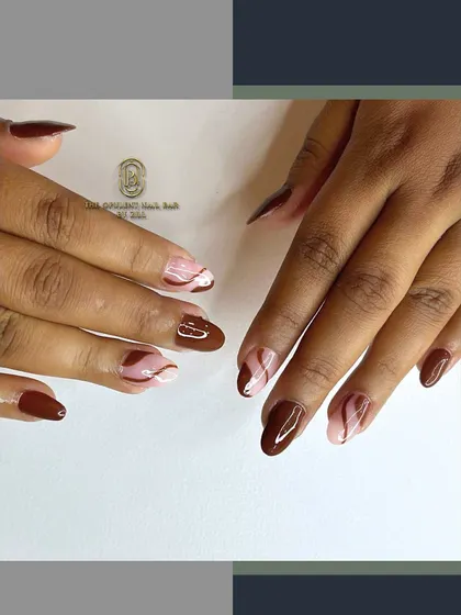 Inspired by a cup of coffee, this design features rich brown polish with creamy white swirls. It's a chic and sophisticated look that's perfect for autumn.