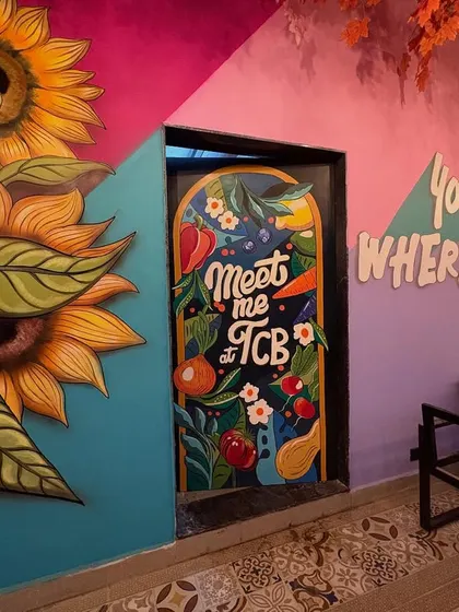 I love adding playful details, like this kitchen door art that says "Meet me at TCB" surrounded by colorful vegetables and flowers.