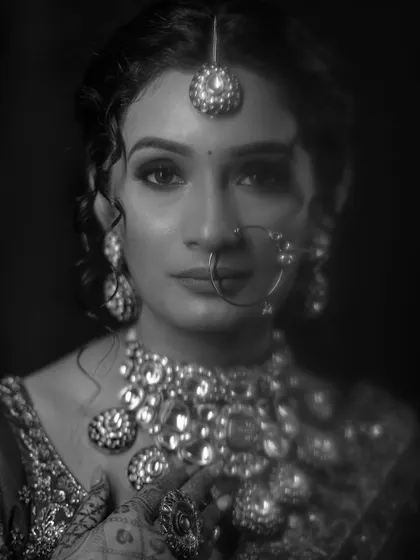 A striking black and white bridal portrait. The intense gaze and the detailed jewelry create a powerful and captivating image that is both modern and timeless.