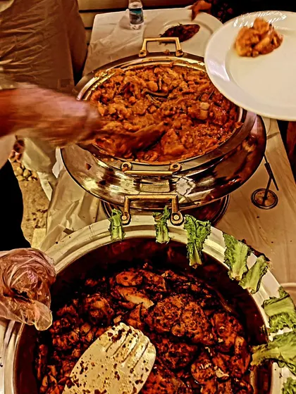 A guest being served from our buffet. This event featured a traditional Kutchi Memon menu with mutton korma and tandoori seer fish, showcasing our expertise in regional cuisine.