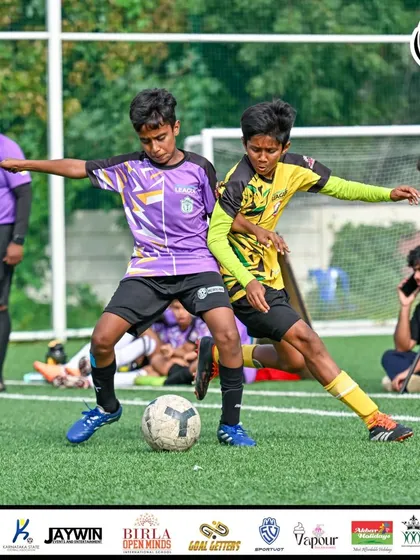 Two players locked in a physical duel for the ball.