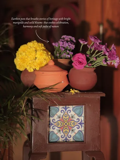 An annotated image highlighting the use of earthen pots with marigolds and wild blooms, evoking a sense of heritage and natural harmony.