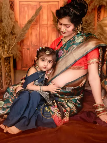 The special bond between a mother and her daughter during a maternity session. The daughter rests against her mother, creating a quiet, intimate portrait.