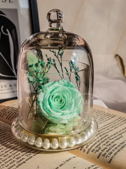 Another view of the mint green Eternal Rose in its glass dome.