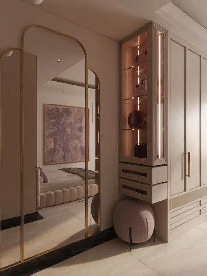 A full-length arched mirror and a lit display niche are cleverly integrated into the wardrobe unit, blending function with beauty.