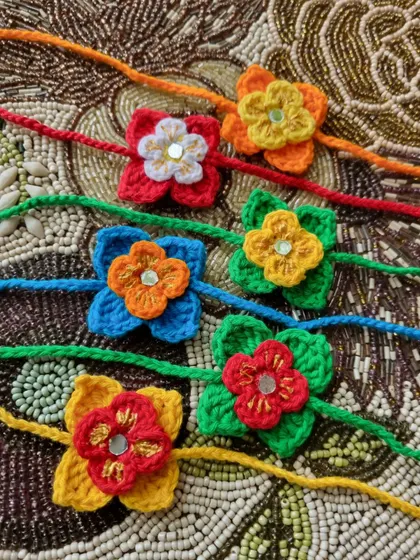 A colorful assortment of our small flower rakhis. Each one is crafted with a mirror work center for a little bit of sparkle.