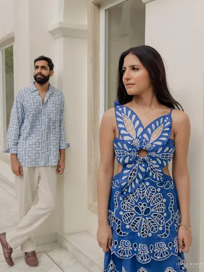 A stylish, composed portrait that still feels intimate and connected. The couple's coordinated outfits and the modern setting create a sophisticated pre-wedding look.