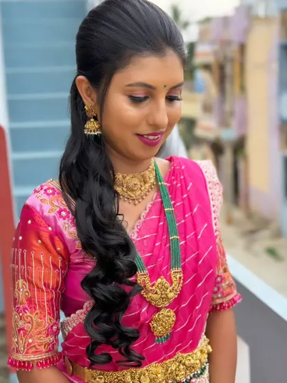 Akshata's complete look. The half-up, half-down hairstyle with soft waves is a great choice for pre-wedding events.