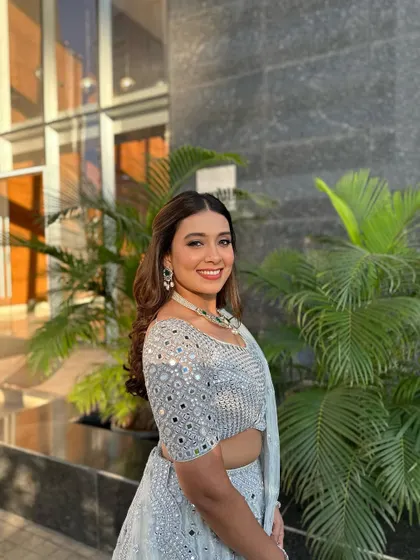 A beautiful, happy client enjoying her post-wedding glow with a simple and elegant hairstyle.