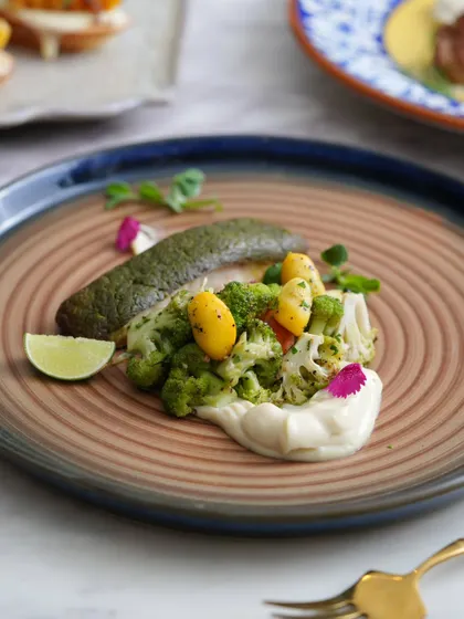 A beautifully plated fish dish with steamed vegetables. Healthy, light, and full of flavor.