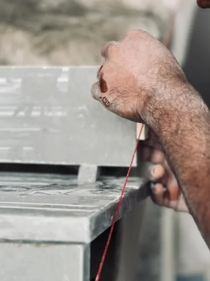 A collection of images and videos documenting various stages of construction, from site visits and foundation work to the detailed installation of architectural fittings and finishes.