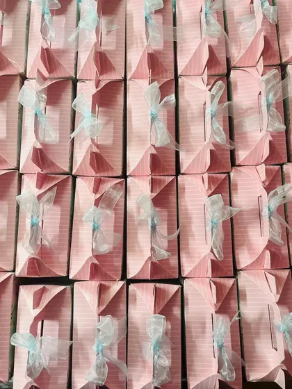 A top-down view of neatly arranged pink favor boxes. This pattern shot emphasizes the uniformity and scale of my bulk order services.