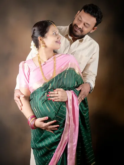 A loving gaze between partners during their traditional maternity shoot in our studio.
