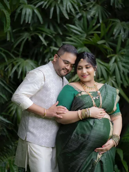 An intimate couple's portrait surrounded by rich green foliage. Outdoor settings like this provide a beautiful, natural backdrop for capturing your connection.