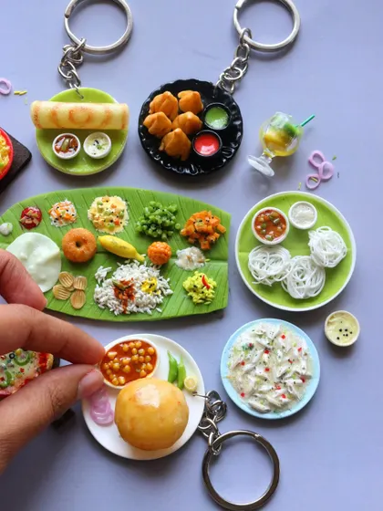 A wide assortment of miniatures, including dosa, idiyappam, chole bhature, and a full South Indian thali.