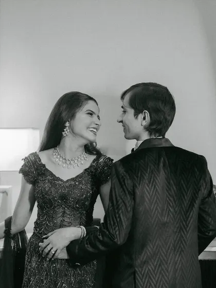 A candid moment of joy. This black and white photo emphasizes the emotion and connection, with the bride's radiant makeup shining through.