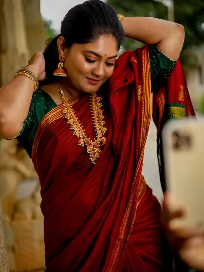 A modern twist on a traditional shoot, with the model taking a selfie. The makeup is designed to be "selfie-ready," looking just as good on a phone camera as it does in professional shots.