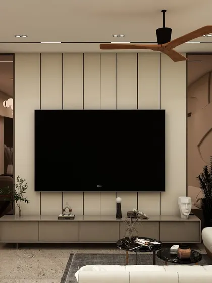 The TV wall in this living room combines vertical fluting with tinted mirrors, creating a sophisticated backdrop that enhances the sense of space.