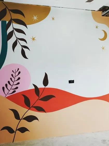 A hand-painted wall mural designed to bring energy and color into a modern space. This abstract piece uses a palette of warm and cool tones, organic shapes, and celestial elements to create a playful and artistic focal point.