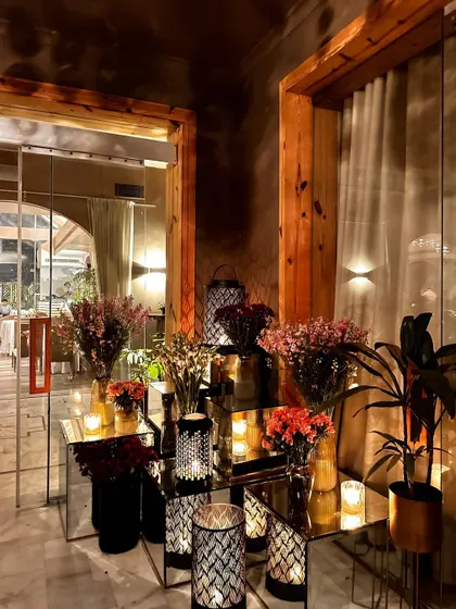 Another view of the indoor decor, showing how I use wood, glass, and florals to create a warm and sophisticated entryway.