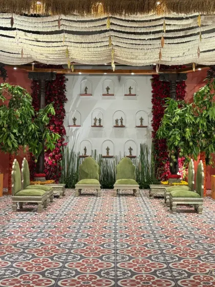 Welcome to 'Divya Stambh', a majestic celebration that transports you to a South Indian temple sanctuary. The design features sculpted stone pillars, rich brass accents, and lotus motifs, creating a deconstructed yet divine experience.