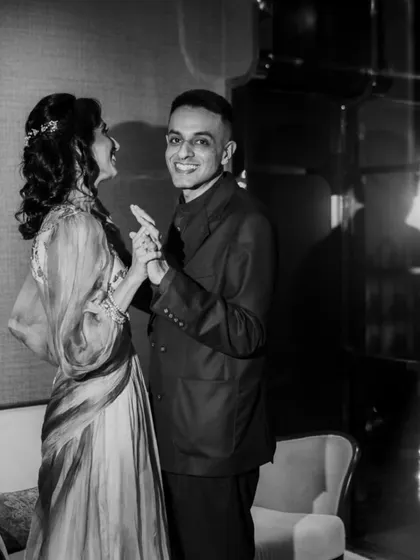 A candid moment of dance and laughter during the celebration. This black and white photo captures the energy and happiness of the event.