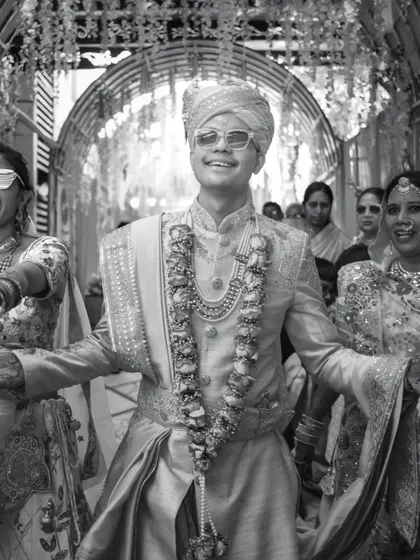 The groom's joyful entrance, full of energy and style. This black and white shot captures the excitement of the Baraat.