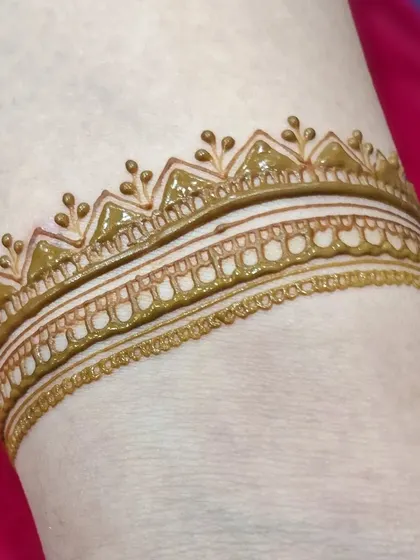 A close-up of a simple yet elegant wristband design. This is a great option for someone who wants a very subtle touch of henna.