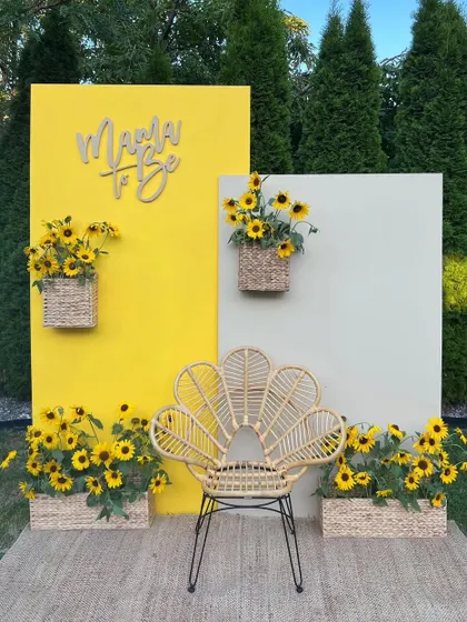 A "Mama to Be" baby shower with a sunflower theme. The bright yellow backdrop and abundant sunflowers create a cheerful and sunny celebration.
