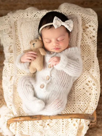 A sleeping newborn is one of the most peaceful sights in the world. I gently posed this little angel with her tiny teddy bear, capturing her innocence in a soft, timeless portrait.