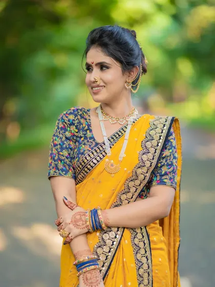 A happy bride in her element. The makeup is kept fresh and natural to complement the outdoor setting and the beautiful yellow saree.