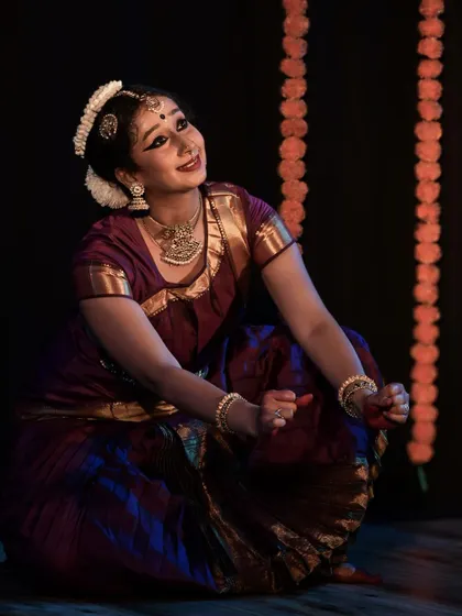 A moment of storytelling, where the dancer's expression conveys the narrative.