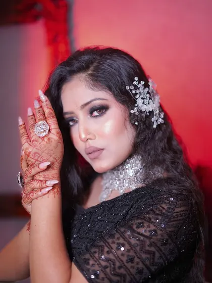 A close-up of the black sequin lehenga, showing the beautiful hand and nail art that complements the look.