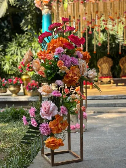 A modern floral arrangement in a geometric metal stand, adding a contemporary touch to the event decor.