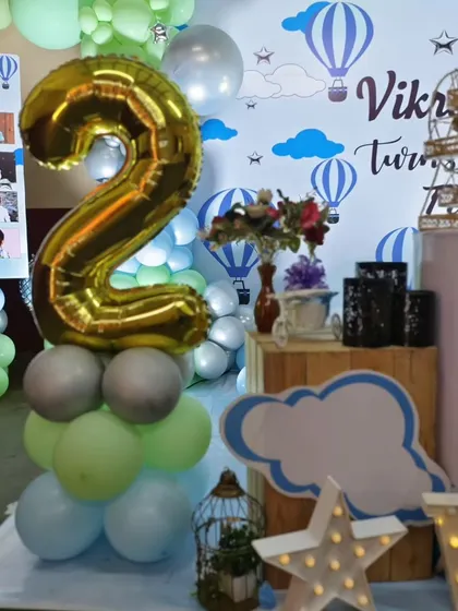 A close-up of the light-up number '2' balloon and other decorative details.