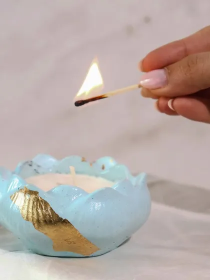 Lighting up one of our lotus jars. The combination of the pastel color, gold leaf, and warm flame is just magical.