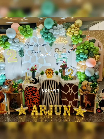 A fun jungle safari theme for Arjun's second birthday, with cute cartoon animal props like a lion, panda, and giraffe.