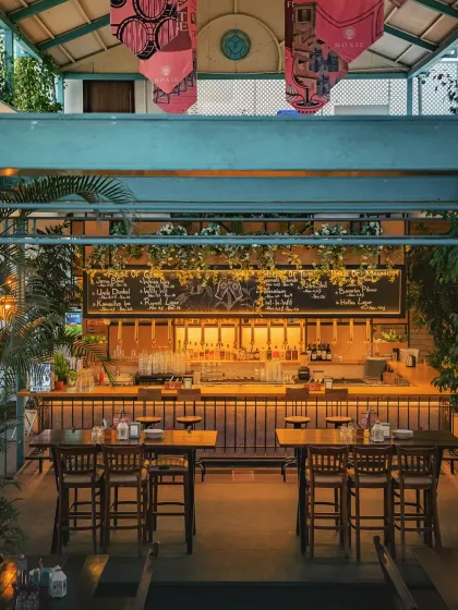 A view of our main bar area, ready for the evening. The high ceilings and open layout can accommodate larger groups, while the warm lighting and wooden textures maintain an intimate feel.