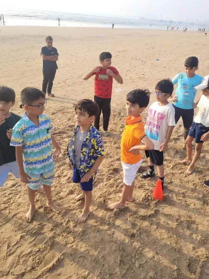 The team huddles up on the sand before a game. We bring the games and gear, you just bring the kids!