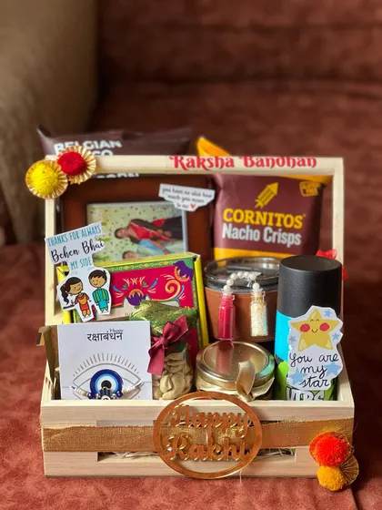 A wooden crate hamper for a sibling, personalized with a photo frame and fun stickers.