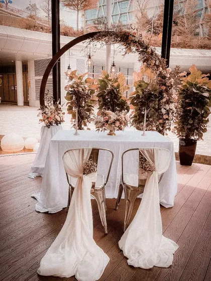 I collaborate with restaurants and pubs to elevate your private events. This intimate table for two is enhanced with a dramatic floral arch and elegant chair dressings for a special ring ceremony or anniversary dinner.