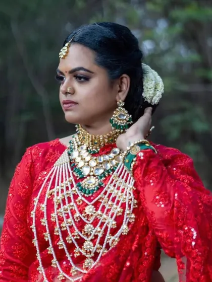 A beautiful profile shot of the bride, showcasing the elegant Kundan choker and oversized earrings. This set is perfect for a grand wedding reception.