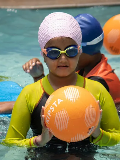 Fun and games with a friendly match of water polo. Activities like these help improve water confidence, teamwork, and agility in a playful way.