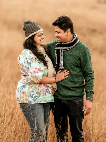Dressed in cozy winter wear, this couple shares a look of love amidst a field of golden grass. My sessions are relaxed, allowing for natural interactions like this that truly reflect the connection between two people.