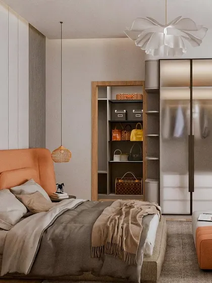 A view of the orange-themed bedroom that includes a frosted glass wardrobe. The open shelving is perfect for displaying a handbag collection, adding a personal and stylish touch.