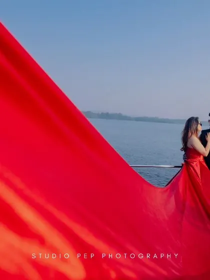 A creative and dramatic shot where the bride's long, red dress fills the frame. This artistic composition is bold, modern, and utterly unforgettable.