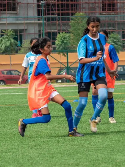 A young player from our sub-junior team focuses on the ball, demonstrating the determination we instill in our future stars.
