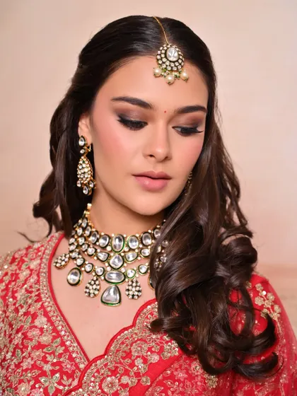 A detailed close-up of the eye makeup for this red bridal look, showing a perfectly blended brown smokey eye.