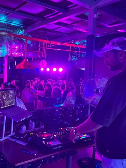 Behind the decks at Geist Brewing Co. with the crowd going strong under the purple lights.